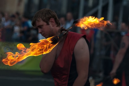 Orenburg, Russia - 25.07.2014: Juggling burning torches at sporting eventsのeditorial素材