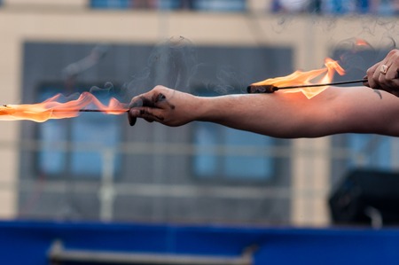 Orenburg, Russia - 25.07.2014: Juggling burning torches at sporting eventsのeditorial素材