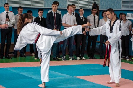 Orenburg, Russia - 23 April 2016: Taekwondo girl fingers legs pulls out a pencil Cup on Championships city among girlsのeditorial素材