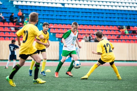 Orenburg, Russia - 1 June 2016: The boys play football in the preliminary games football festival "Lokobol-2016"のeditorial素材