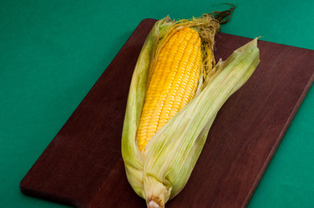 Corncob cooked corn lies on cutting board