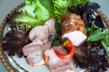 Assorted meat with fresh Greens on the table on the dining tableの写真素材
