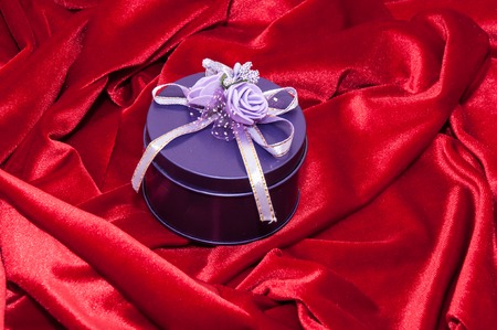 Gift in a box decorated with colorful ribbonsの写真素材