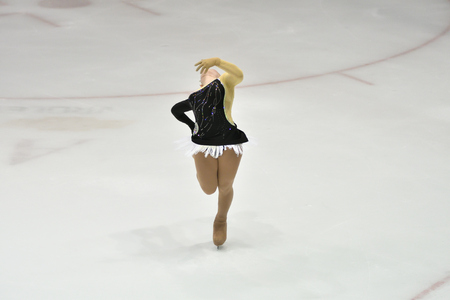 Girl skater skates on ice sports arenaの写真素材