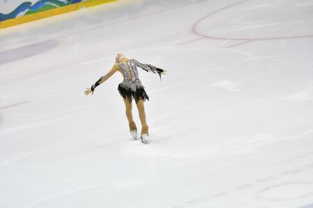 Girl skater skates on ice sports arenaの写真素材