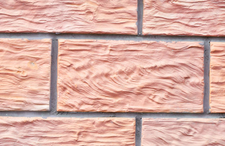The texture of the building material from which the wall is built