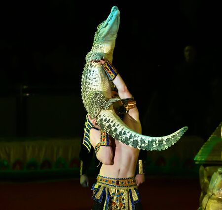Orenburg, Russia - October 12, 2019: Trainer and crocodile in the circus arenaのeditorial素材