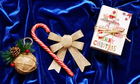 Christmas decorations and a gift on a blue backgroundの写真素材