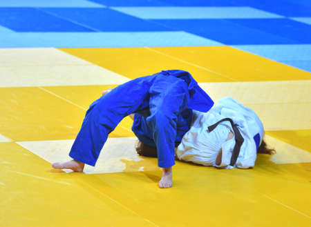 Two Girls judoka in kimono compete on the tatamiの写真素材