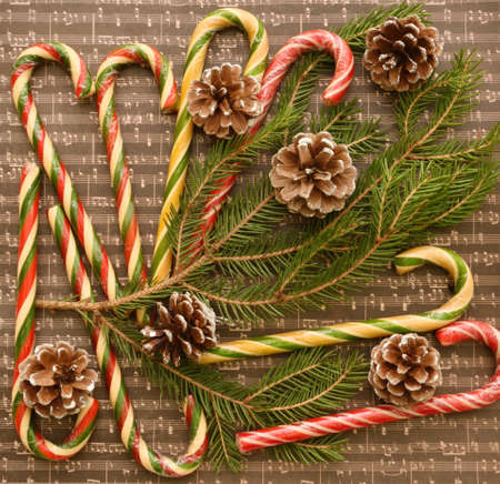 Christmas caramel or Christmas caramel canes, a branch of an ordinary spruce and fir conesの写真素材