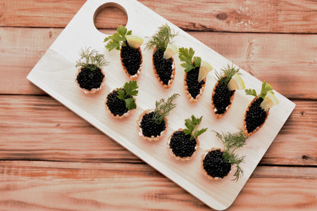 Tartlets with caviar and fresh herbs for the New Year's tableの写真素材