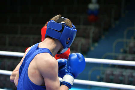 Two young boxers compete in a boxing ringの写真素材
