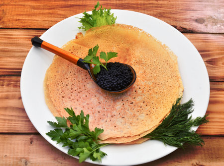 Pancakes with black caviar, cooked for Maslenitsa. Maslenitsa is an East Slavic traditional holiday celebration during the week before Lent.の写真素材