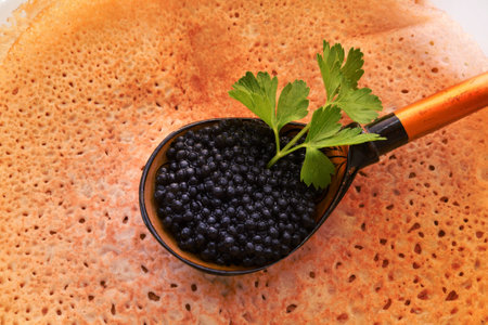Pancakes with black caviar, cooked for Maslenitsa. Maslenitsa is an East Slavic traditional holiday celebration during the week before Lent.の写真素材