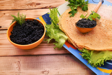 Pancakes with black caviar, cooked for Maslenitsa. Maslenitsa is an East Slavic traditional holiday celebration during the week before Lent.の写真素材