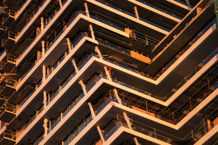 Laborers working on the contruction of big skyscraperの写真素材