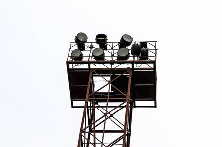 Industry. A tower with powerful spotlights to illuminate the area against the sky.の写真素材