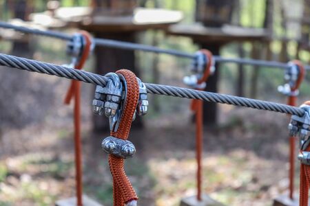 Rope holding a log bridge, part of the cableway. Close-up. Extreme sport.の写真素材