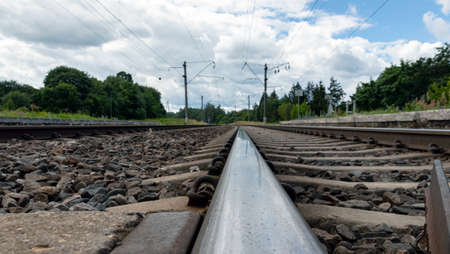 Railway rail running to the skyline. Close-up.の写真素材