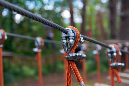 Rope holding a log bridge, part of the cableway. Close-up. Extreme sport.の写真素材