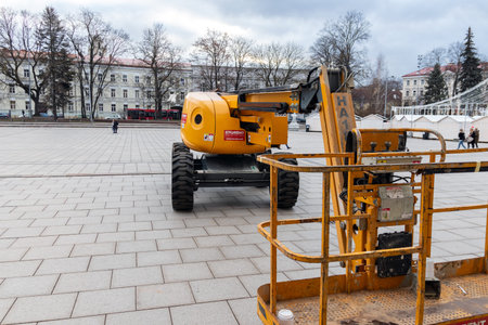 12-19-2019. Vilnius, Lithuania. Yellow construction hoist on a city square.