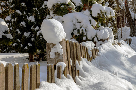 Wooden fence covered with snow. Freezing day. close-up.の写真素材