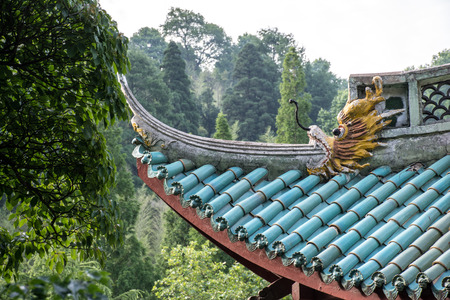 Chinese dragon on a temple's roof. The roof in the east style with a dragon and the blue tilesのeditorial素材