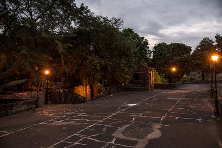 Night street in a residential area. Evening lights on the street at sunset. View of the street with lanterns and treesの写真素材