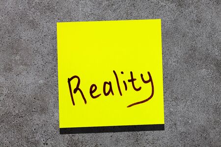 sticky leaf on the wall. inscription marker word realityの写真素材