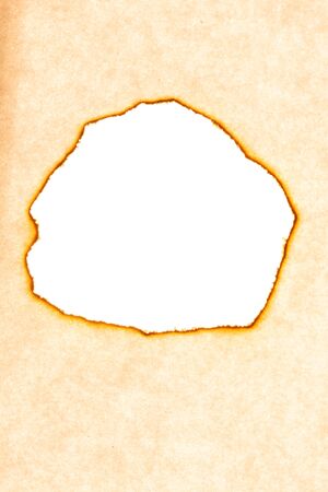 old burnt paper. round hole in the middle. background for design. High quality photoの写真素材