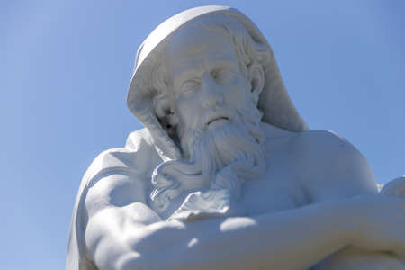 Russia. Vyborg. 06.30.2020. Statue of an old man on a background of blue sky.のeditorial素材