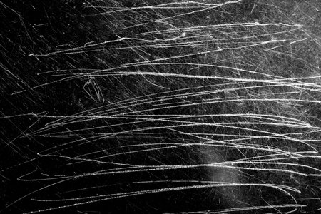 white scratches with scuffs on a black backgroundの写真素材
