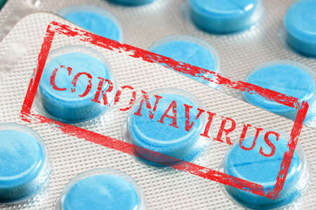 stamp with the inscription coronavirus on the background of a blister with pillsの写真素材