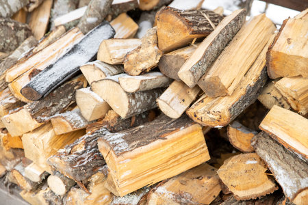 wood in a heap with snowの写真素材