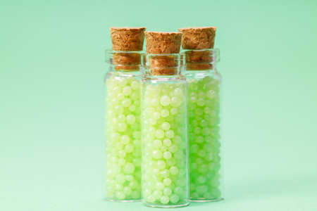 glass bottles with corks with green granulesの写真素材