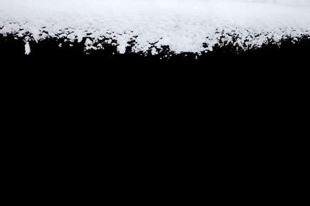 strip of snow isolated on a blackの写真素材