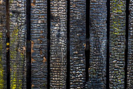 the charred wall of the house. building after the fire. wooden texture after fire. High quality photoの写真素材