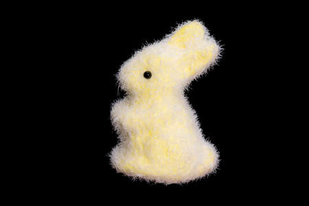 toy yellow hare isolated on black background. fluffy bunny. Easter. High quality photoの写真素材
