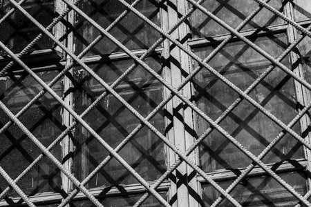 metal grates on the windows. black white photo. High quality photoの写真素材