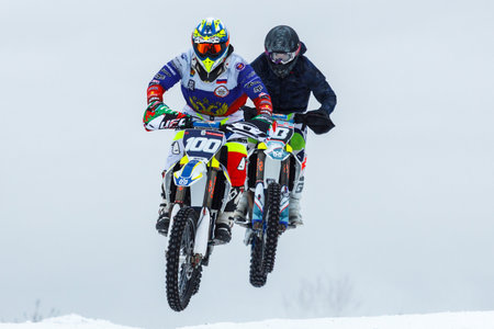 Russia. Vyborg 01.01.2021 Motorcyclists ride on the snow on the roadのeditorial素材