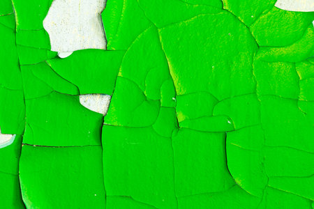 stone wall with green cracked plaster. background for design. grunge texture