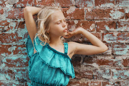 girl posing at a brick wallの写真素材