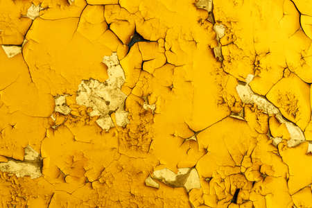 concrete wall with yellow paint in cracks. background for design. grunge textureの写真素材
