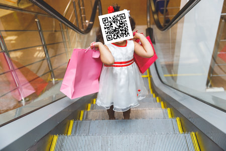 girl with qr code on her face holds packages with purchases. The concept of restrictions on the non-vaccinatedの写真素材
