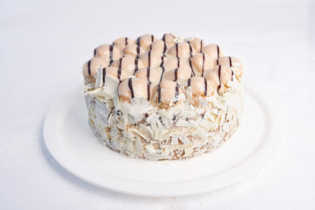 Tasty big piece of cake on a plate on a white background