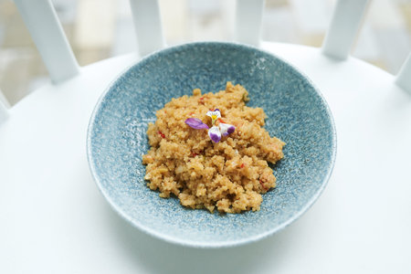 Tasty and healthy quinua on a white plate in daylight