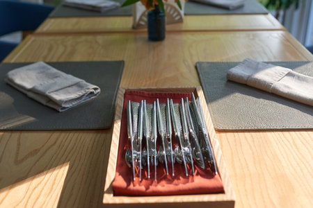 four cutlery on a wooden table in a restaurant close-up