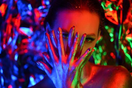 Portrait of beautiful young cosmic woman, girl, model, star, celebrity. Blue background. Bright creative makeup, perfect body, expressive, pose, colors.Elf style.Hair. Fur. High fashion. Neon.の写真素材
