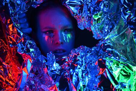 Woman muse with creative body art and hairdo in colourful powder explosionの写真素材