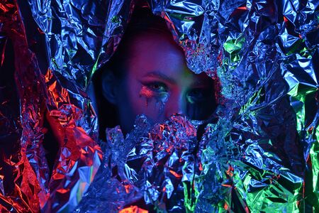 very beautiful young lady with holiday makeup and diamond accessory is waiting for miracle on new year. Winter queen. Ice silver background.の写真素材